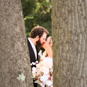 Bride and Groom behind tree