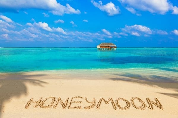 Word Honeymoon on beach - concept holiday background